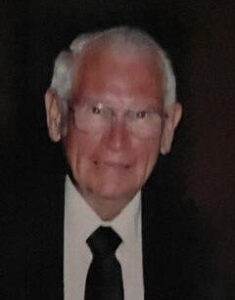 Kind elderly man smiling in formal attire at Dogwood Cremations LLC.