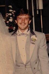 Gentleman in a tuxedo at a wedding or formal event.