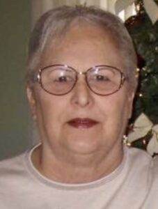 Gentle woman with glasses smiling, memorialized by Dogwood Cremations LLC.