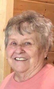 Senior woman smiling, indoor setting, emotional comfort, Dogwood Cremations LLC services.