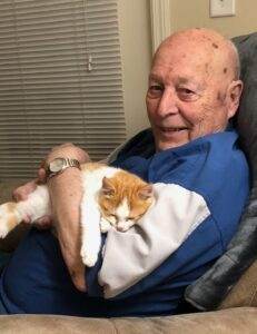 Elderly man holding a kitten, symbolizing pet companionship and grief support at Dogwood Cremations.