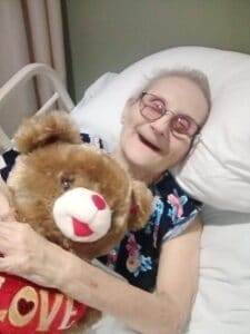 Comforting senior woman with teddy bear, end-of-life support, compassionate pet loss care, Dogwood Cremations LLC.